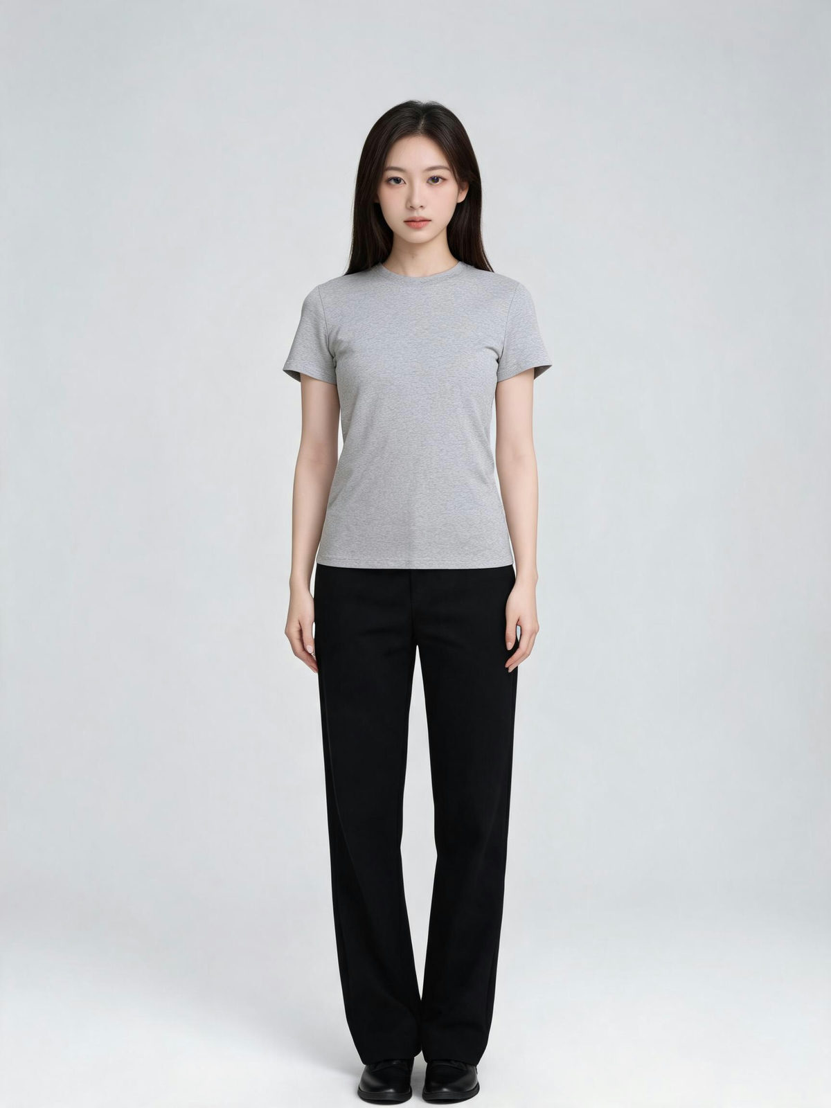 Woman in a plain studio tee before the outfit change