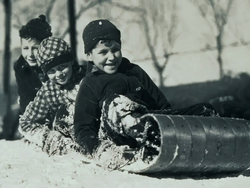 Restored vintage photo of kids on a toboggan after AI upscaling